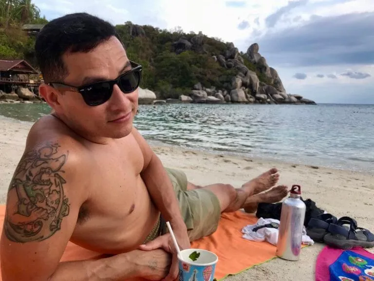 Man on beach looking into camera